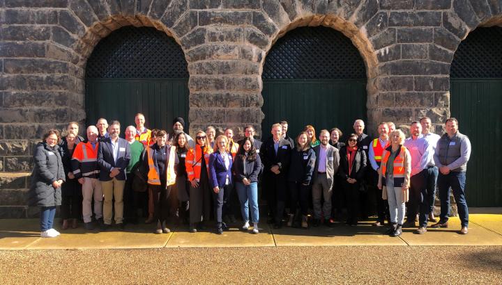 Melbourne Water staff and Victorian Government representatives, embassy officials, guests from Singapore’s National Water Authority, and a number of metropolitan water retailers and water sector peers standing together at Western Treatment Plant