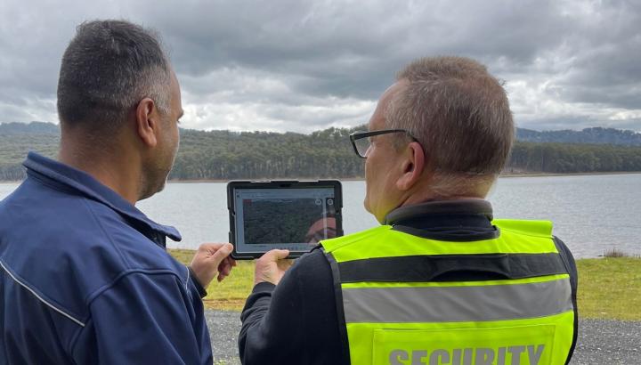 Ram Ramzan and security personnel review drone footage at Silvan Dam