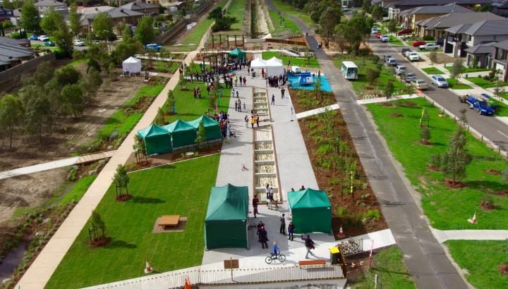 Image shows the transformation of the pipeline into a community park where the open area is covered in grassland and plantings