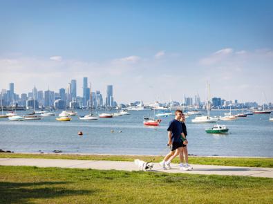 People walking along water