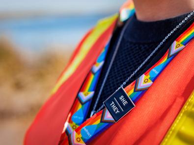 Melbourne water employee wearing intersectional LGBTIQA+ lanyard with she and they pronoun pins