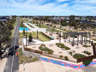 Aerial view of Pilot Park, showing play equipment, grassy areas and a trail running alongside