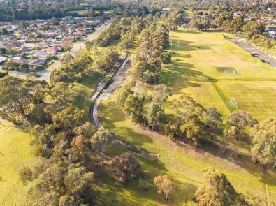 Eummemmering Creek aerial Aerial view of a concreted section of Eumemmerring Creek running through a grassy area surrounded by houses and sporting facilities.