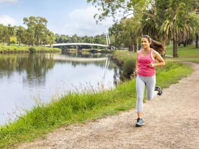 Woman jogs along the Maribyrnong River Trail