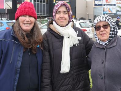 three people gather for tree planting day