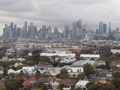View of Melbourne CBD, with houses in the foreground and skyscrapers in the background