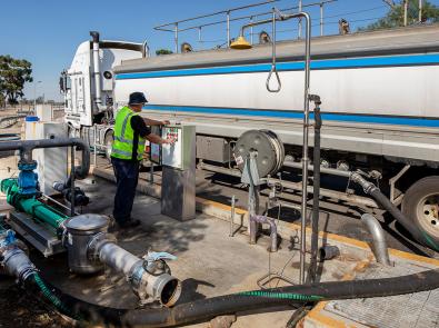 Man next to truck delivering liquid organic food waste