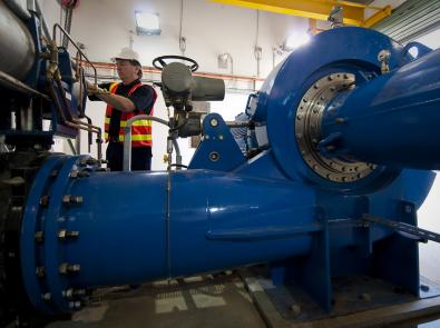 Notting Hill mini-hydro interior with worker Technician in mini-hydro control room
