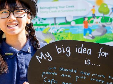 A girl holding up a sign with her big idea for Stony Creek