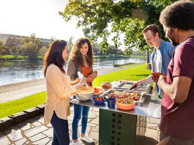 Waterway litter and amenity - barbecue Four people having a barbecue next to a river