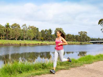 Woman jogging along river