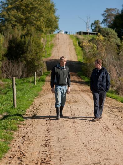 Farmer and MW staff walking along country road
