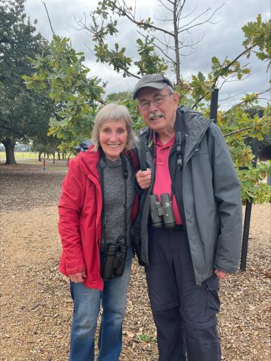 Two people standing and smiling