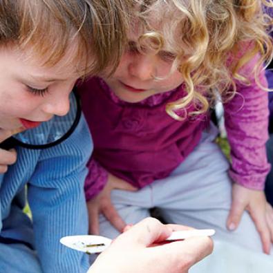 Three children inspecting waterbugs, City of Greater Dandenong 