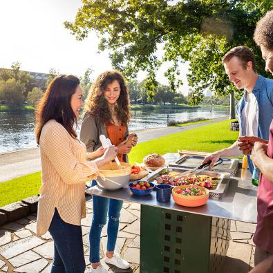 Waterway litter and amenity - barbecue Four people having a barbecue next to a river