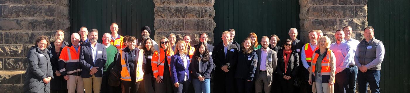 Melbourne Water staff and Victorian Government representatives, embassy officials, guests from Singapore’s National Water Authority, and a number of metropolitan water retailers and water sector peers standing together at Western Treatment Plant