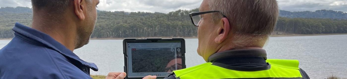 Ram Ramzan and security personnel review drone footage at Silvan Dam