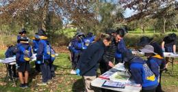 kids learning around tables in park