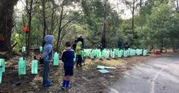 Children stand in front of plant guards