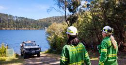 Melbourne Water firefighters with a truck looking over to a reservoir