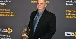 Melbourne Water employee George Vagias holding his WorkSafe Victoria 2021 award.