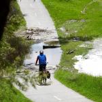 Cyclist riding through floodwater 