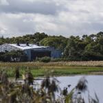 Natural wetland with education centre in the background