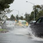 cars driving on flooded road