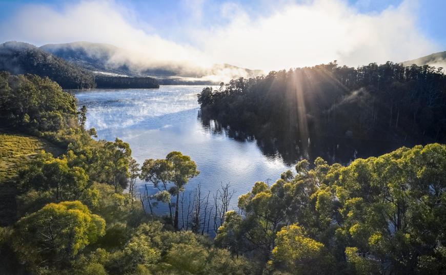 Aerial view of Melbourne reservoir with sunlight reflecting off the water