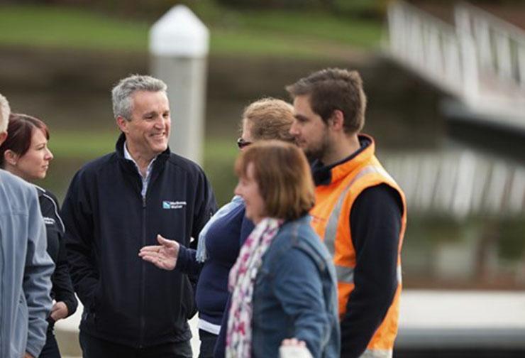 Melbourne Water employee talks to community at Patterson Lakes jetty