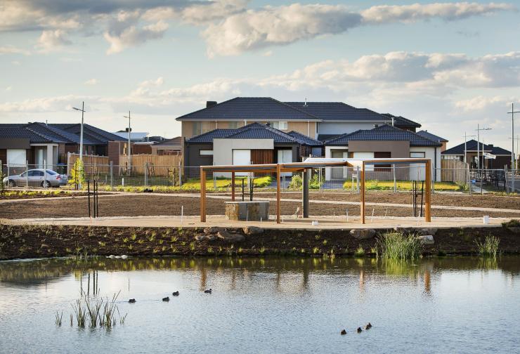Constructed wetland with new housing development in the distance.