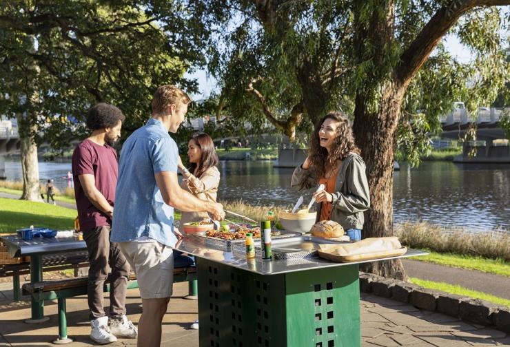 Four people enjoying a barbecue on the Yarra