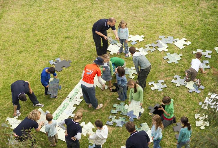 Children put together a giant jigsaw puzzle