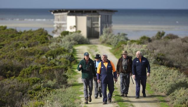 Group of birdwatchers walking from the Western Treatment Plant bird hide