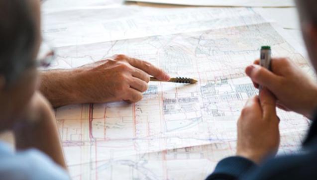 People looking over development plans