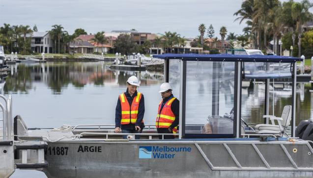 Two Melbourne Water staff members standing at Pattersons Lakes