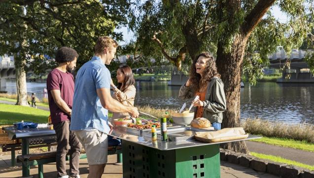 Four people enjoying a barbecue on the Yarra