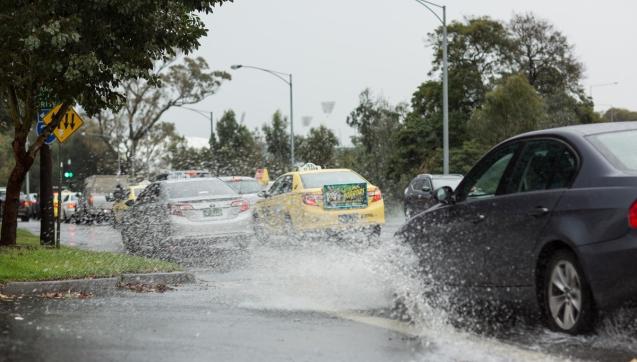 cars driving on flooded road