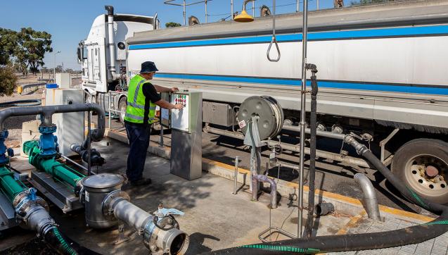 Man next to truck delivering liquid organic food waste