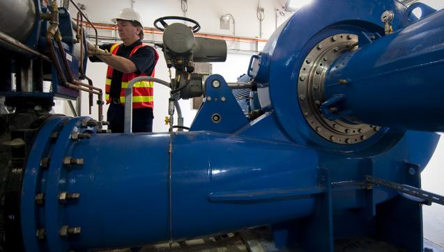 Technician in mini-hydro control room