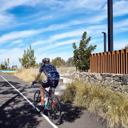 Cyclist rides along Federation Trail next to Pilot Park, built as part of the Greening the Pipeline initiative