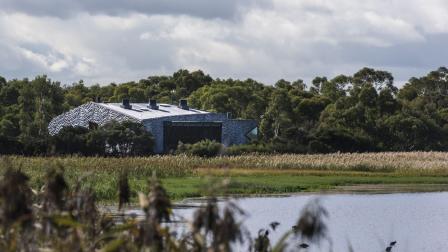 Natural wetland with education centre in the background