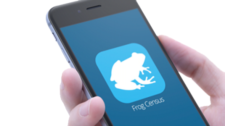 Hand holding a smartphone with the Frog Census app icon on screen