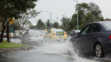 cars driving on flooded road